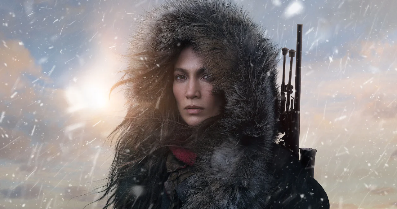 Imagen oficial de la película The Mother: una mujer con capucha de pelo sostiene un rifle en un paisaje nevado